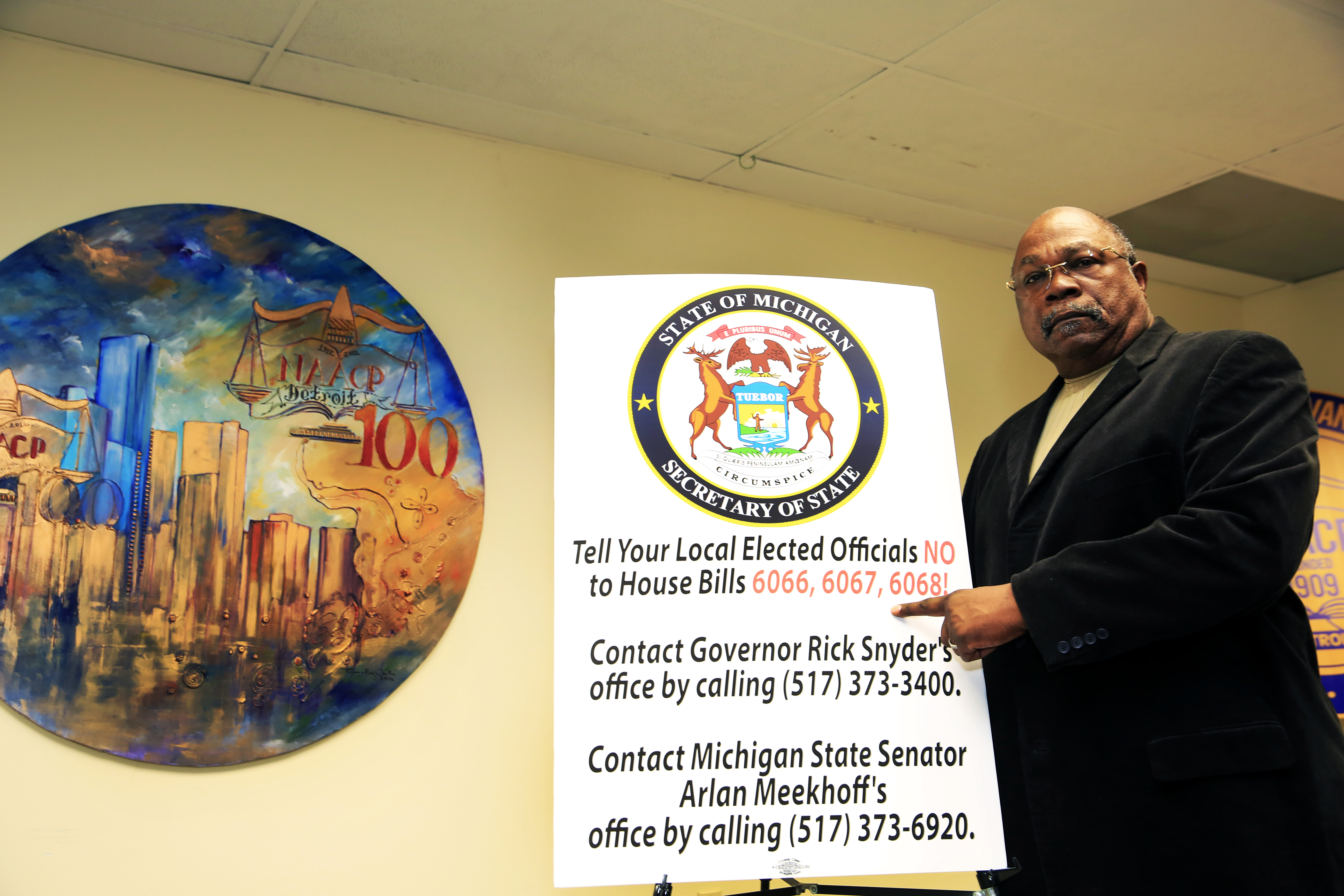 NAACP President Rev. Wendell Anthony at a Thursday press conference points to Michigan House voter suppression legislation currently on its way to the Senate for approval. PHOTO: Monica Morgan