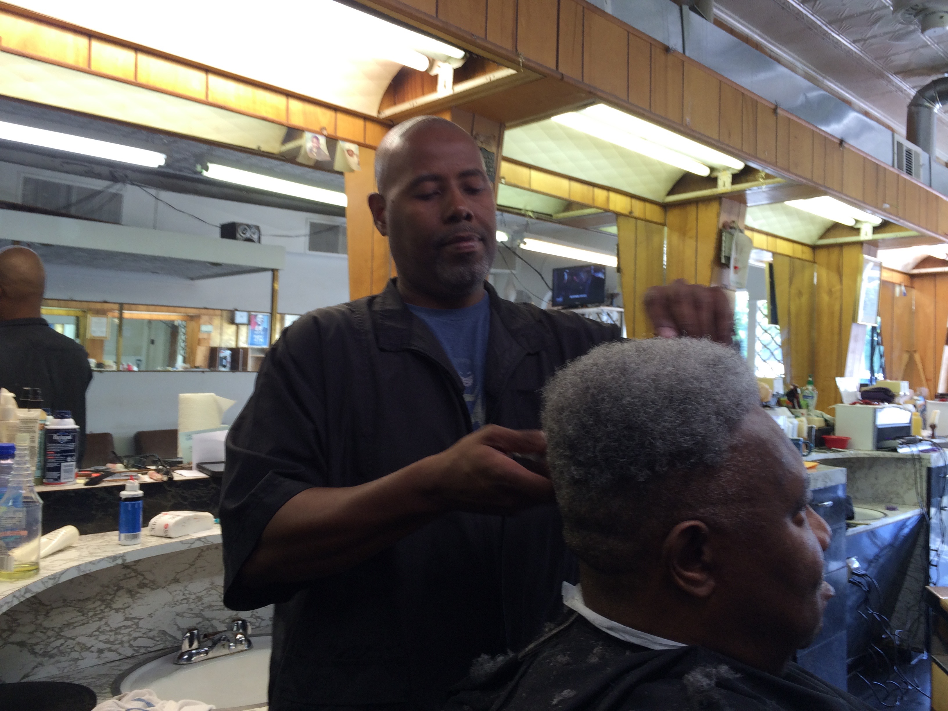 Kenneth Dixon at work in the family business, Dixon's Barber Shop, which has been in existence for three generations. PHOTO CREDIT: Keith A. Owens