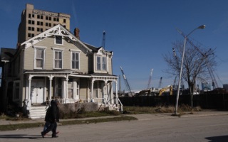 Two children walk down Cass Ave in front of construction of the new Red Wings arena in Detroit. Photo Cfedit: Paul Warner