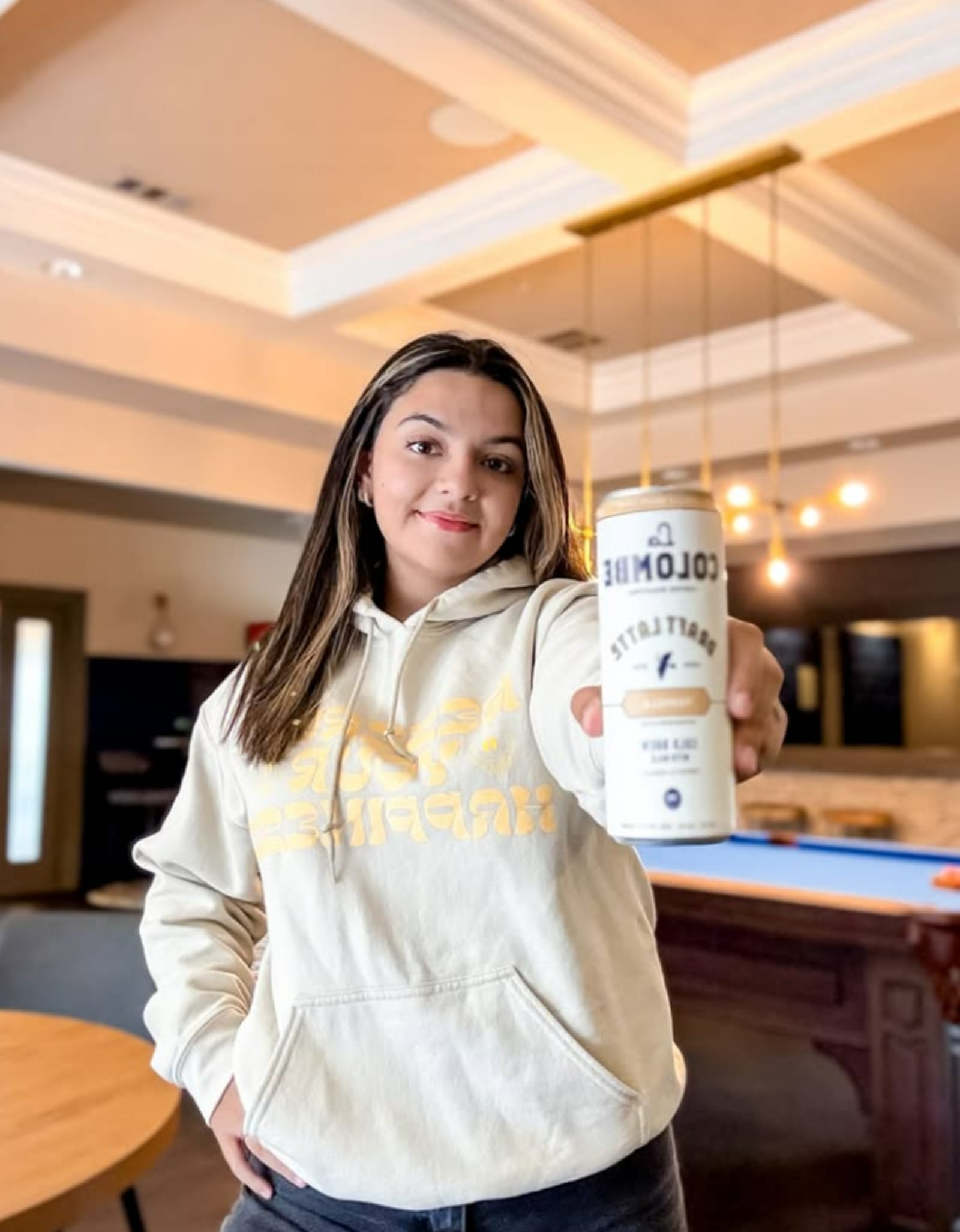 Resident holding a product sample in clubhouse