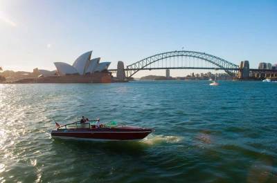 Wooden speed boat cruising Sydney harbour