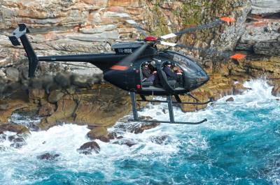 Helicopter flying over the water