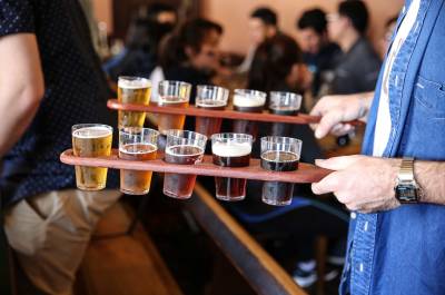 Man holding two beer paddles