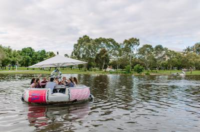 People in a BBQ boat on a river cruise