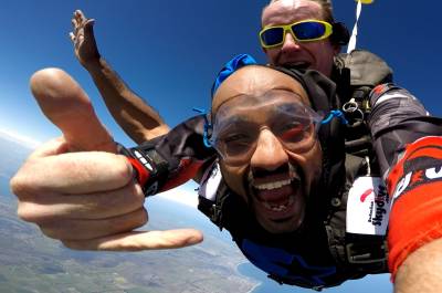 Two men jumping out of a plane while skydiving