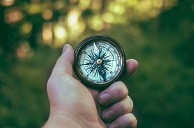 Hand holding a compass