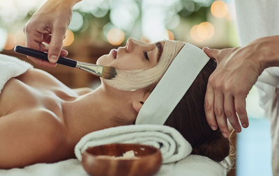 Woman getting facial at day spa