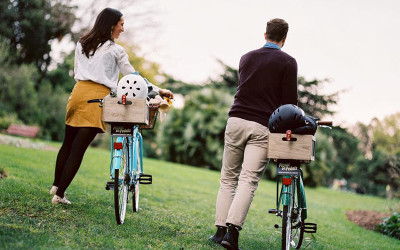 Couple riding bike through park