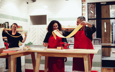 Couple doing pasta making class