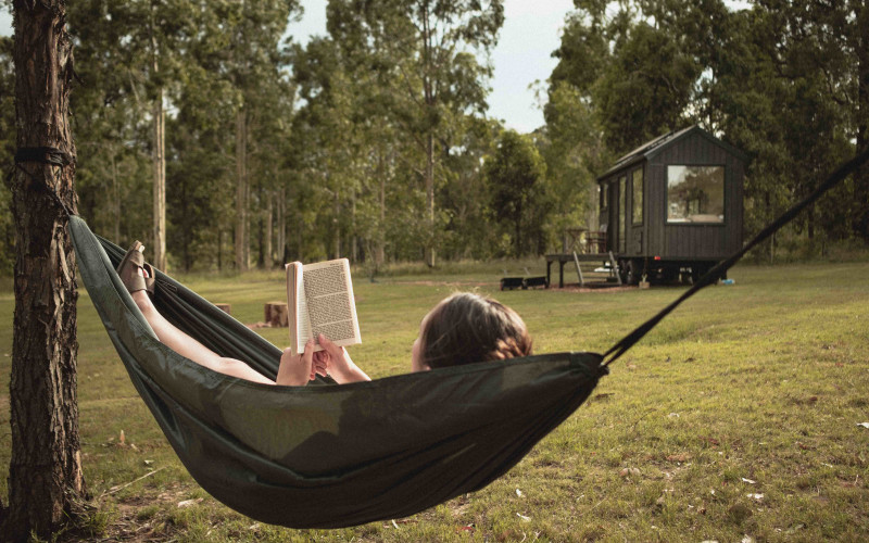 Reading in a hammock outside the Lila off-grid cabin on a Hunter Valley winery