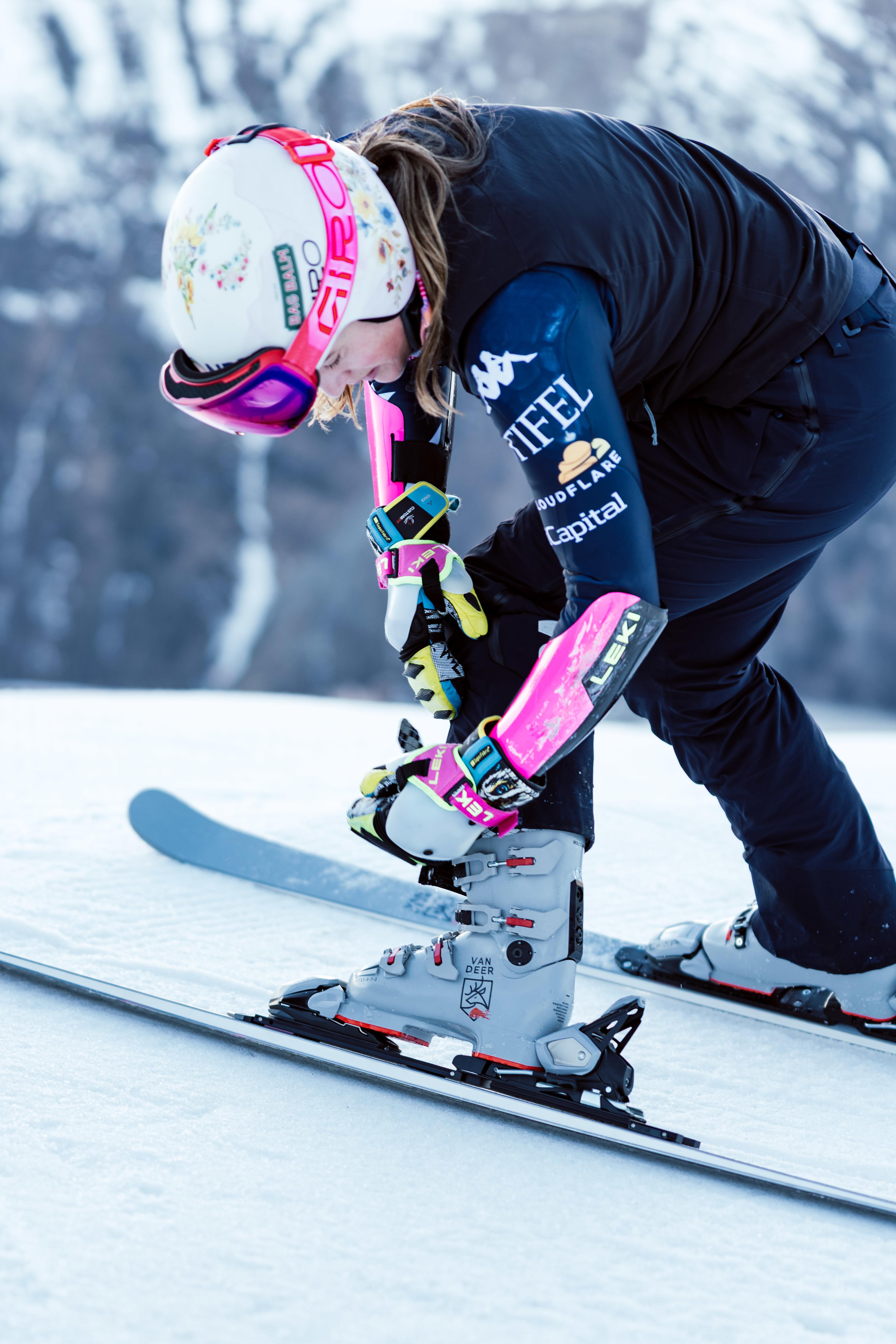 Skirennläuferin schließt ihre Skischuhe.