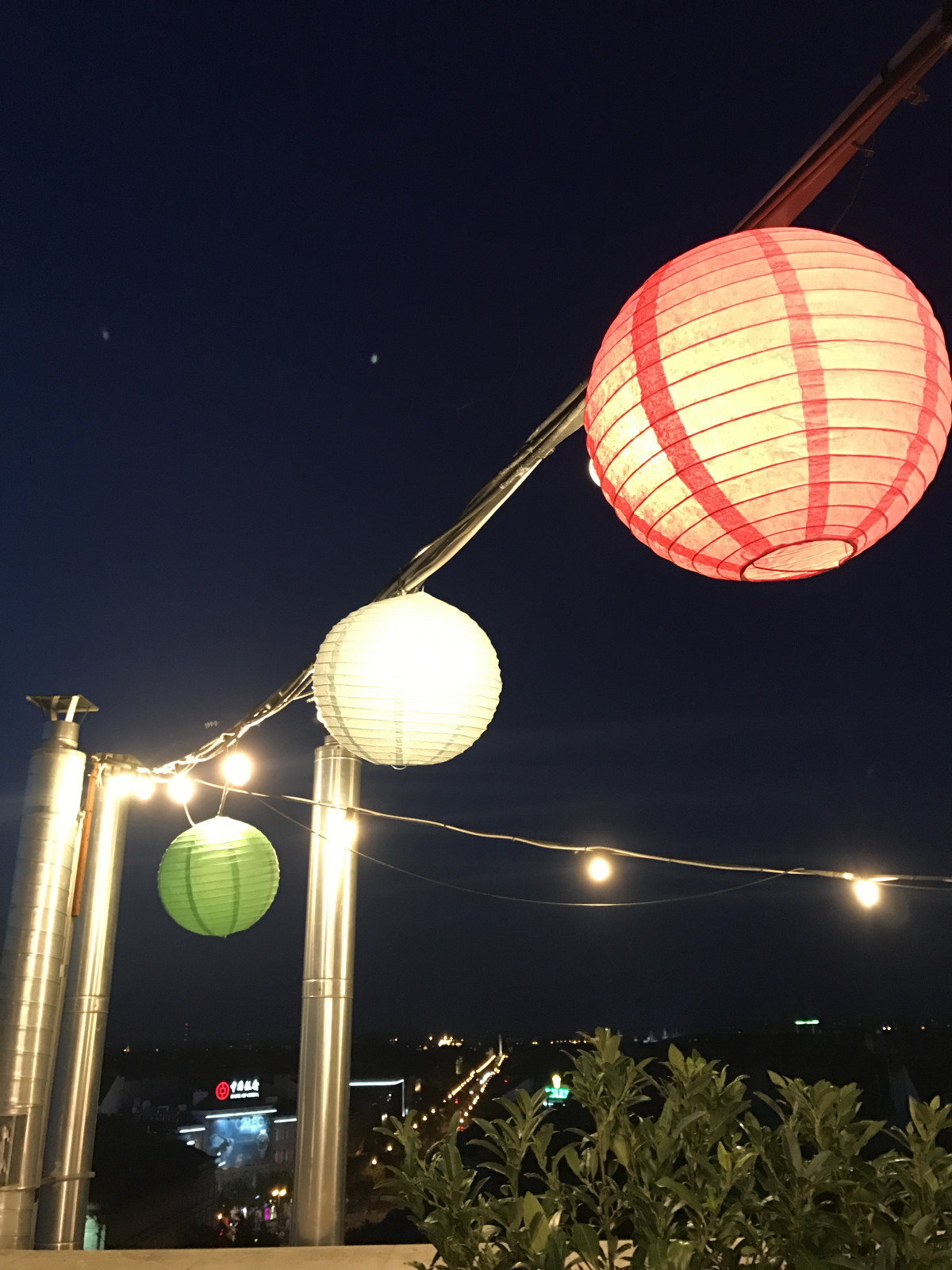 The rooftop was lit with pretty lanterns and fairy light