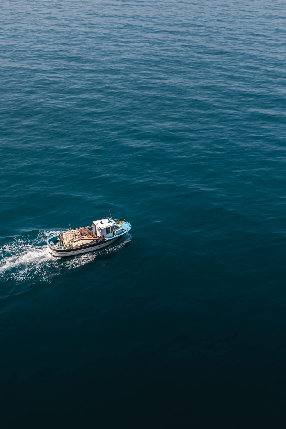 Boats slowly flow below the promontory