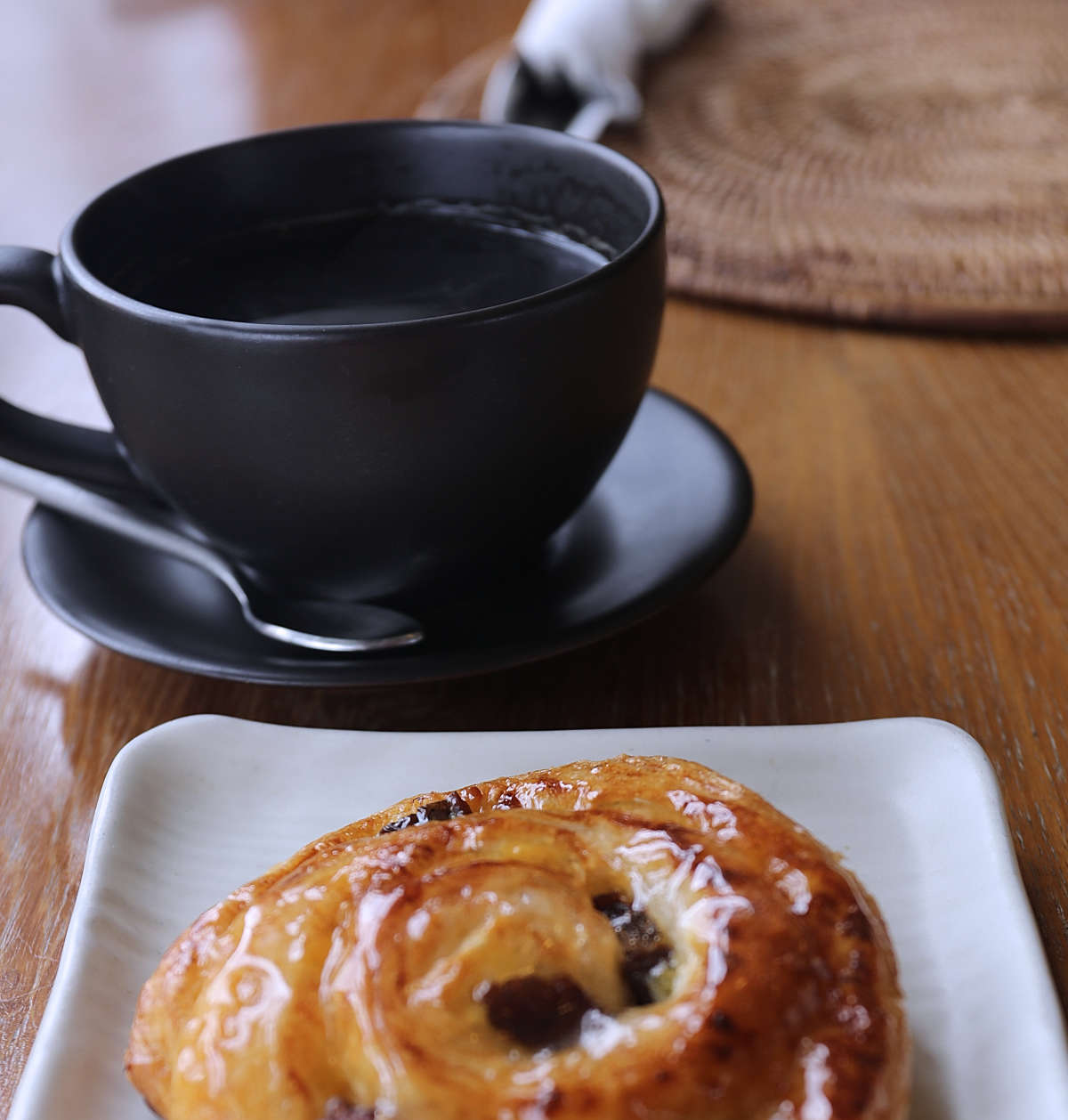 Cup of American coffee and a raisin danish