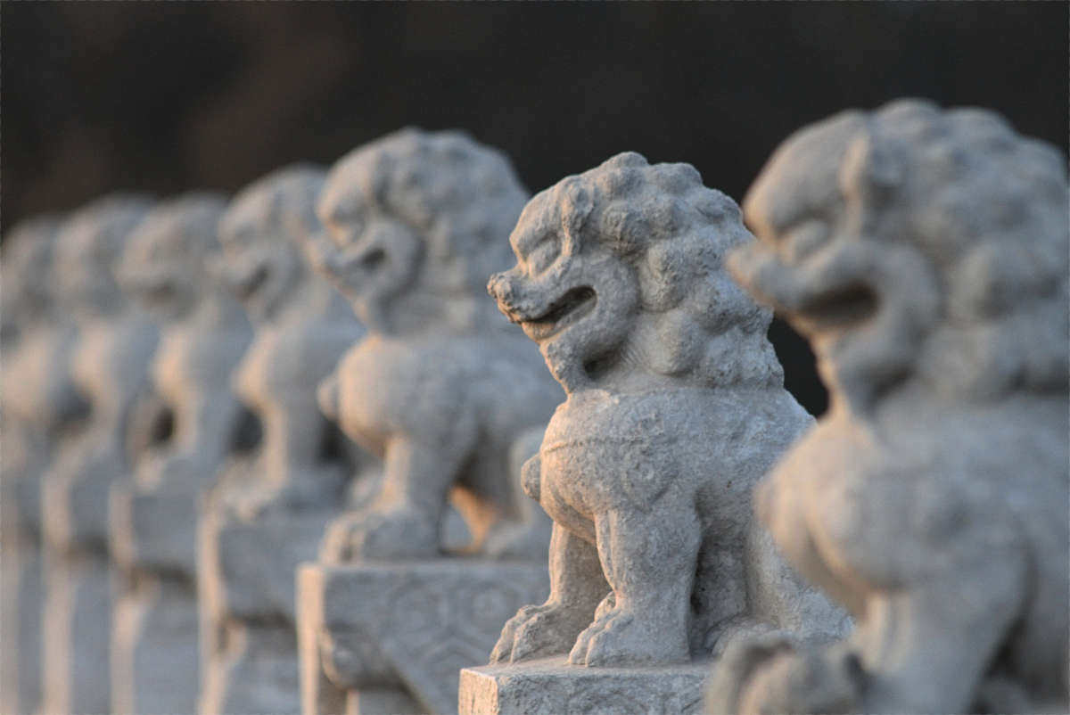 Some of the 544 carved stone lions adorning the Seventeen Arch bridge