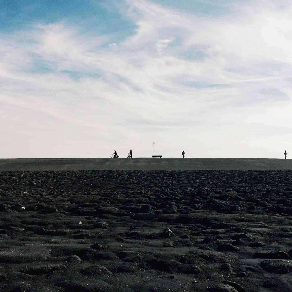 Cyclists and walkers pass each-other on a Westkapelle dyke.    