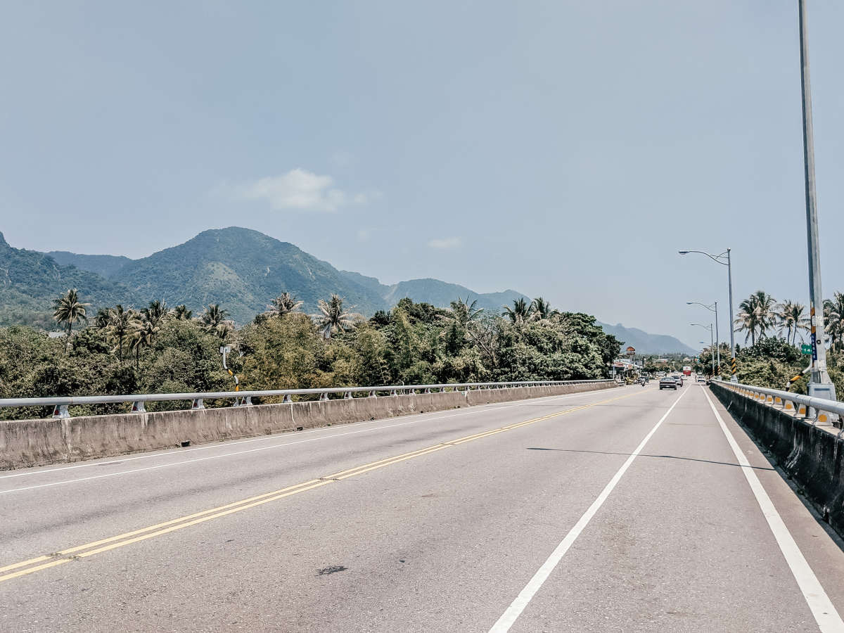 Beach views on one side of the road, mountains on the other