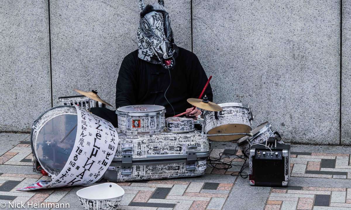 a drummer in front of Takeshita Street
