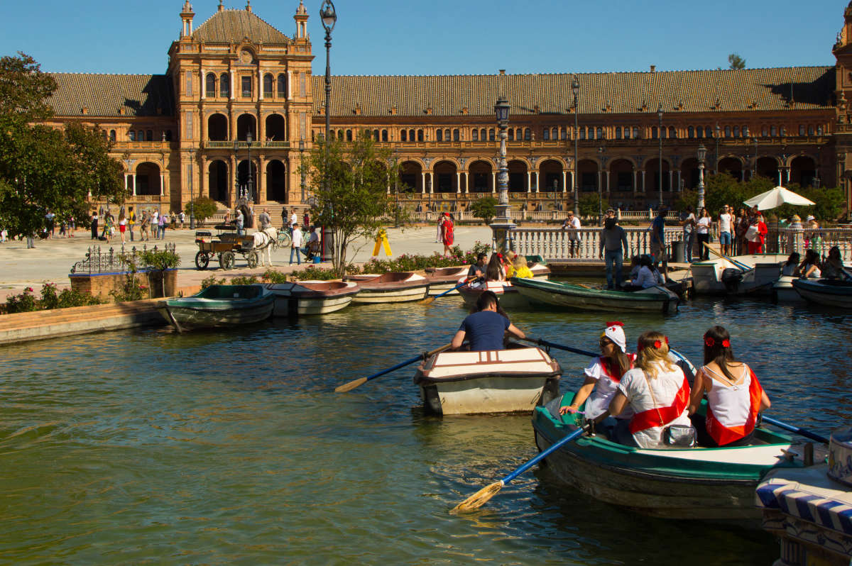 Some people rowing in the canal