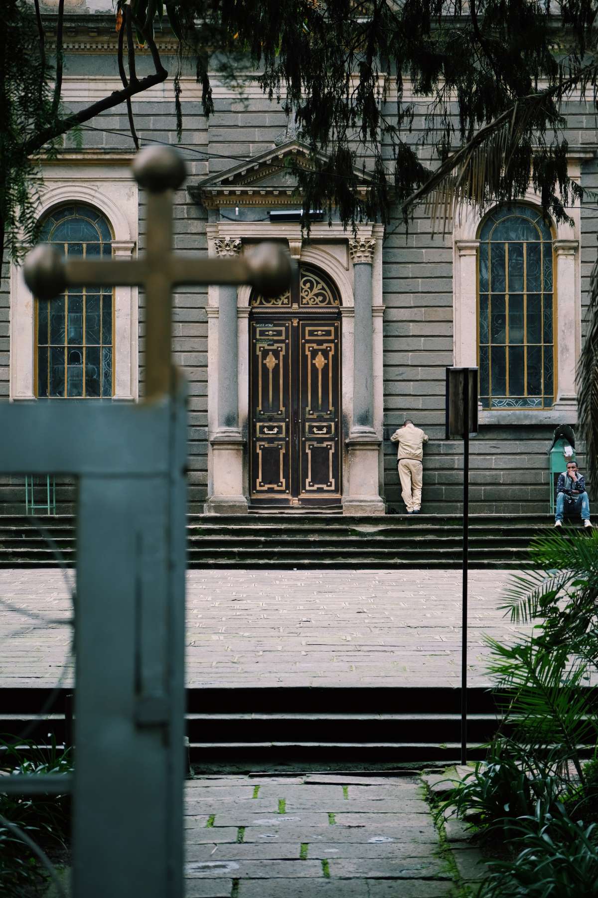 A man prays against St. George Church\x27s exterior