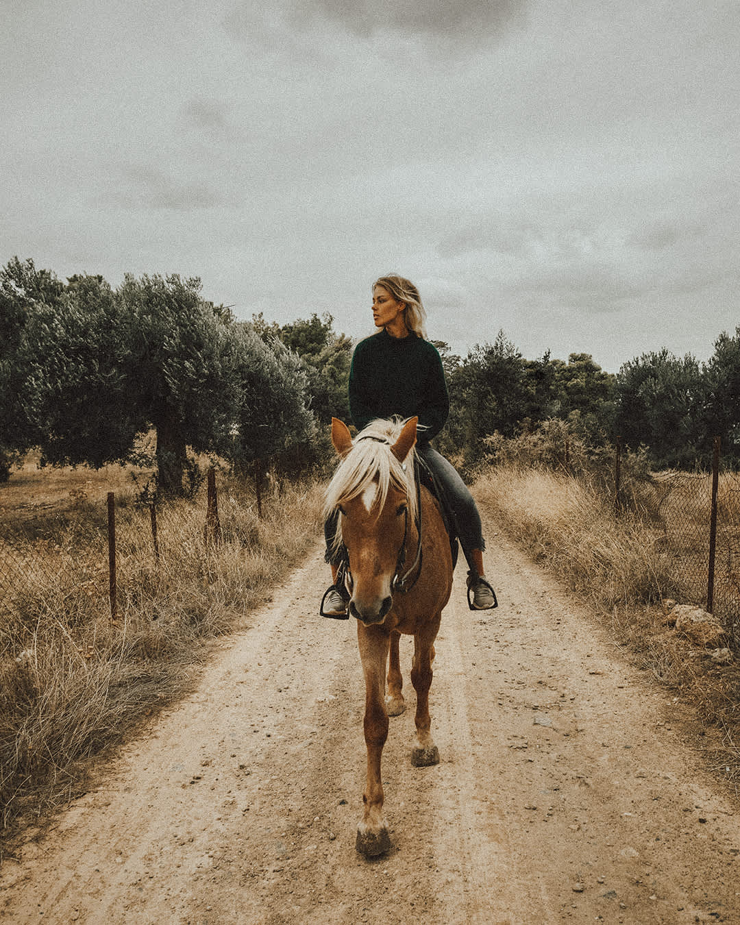 Karolina riding a horse.