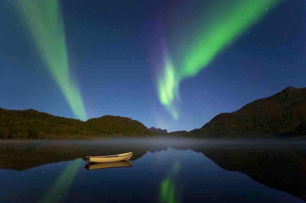 northern lights above the mountains