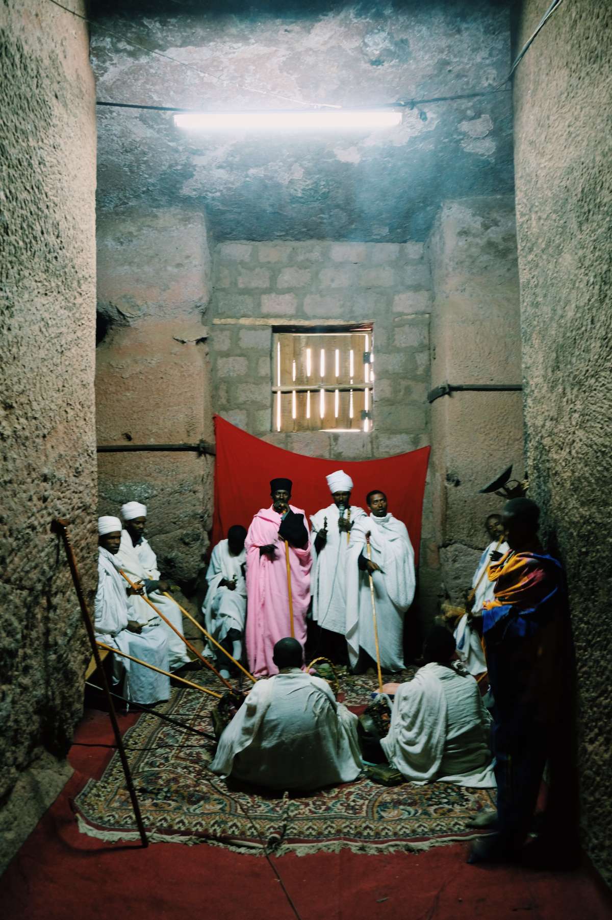 Labilela priests and monks sing prayers in one of the rock-cut churches, very early in the morning