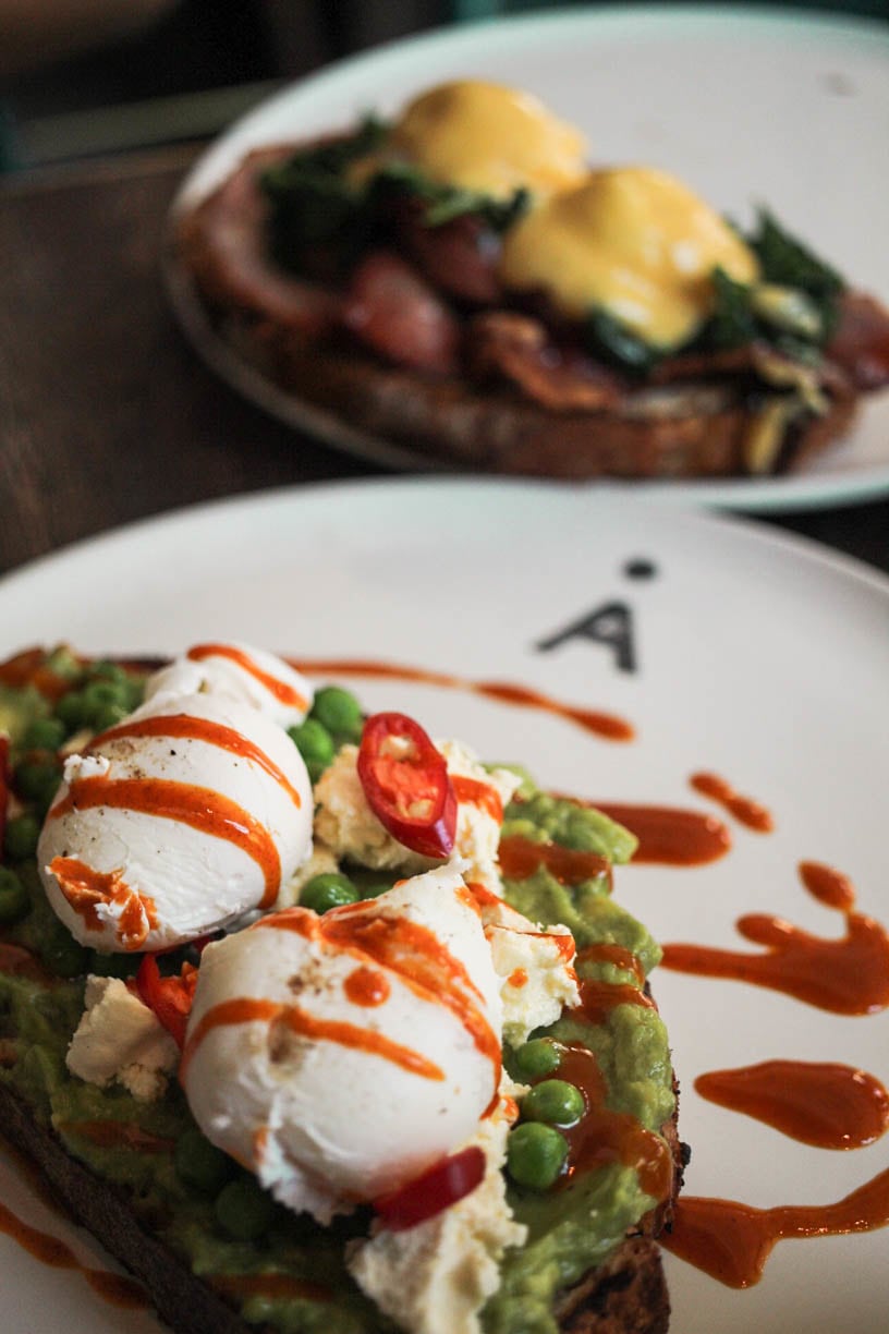 Smashed avocado, Persian feta, poached eggs, chilli, peas and mint on grilled sourdough