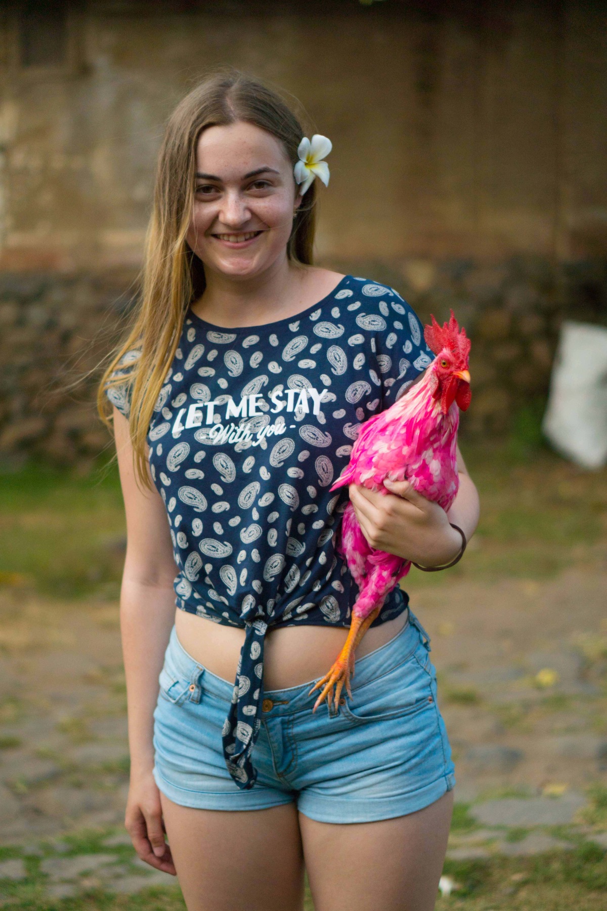 Posing with a rooster at Bali traditional village.