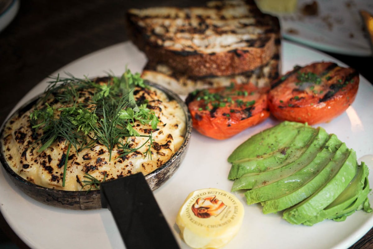 Omelette Arnold Bennett with smoked haddock, grilled tomato, avocado and sourdough