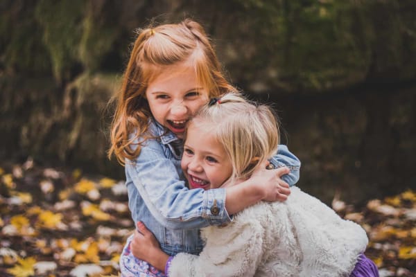 Siblings smiling and hugging