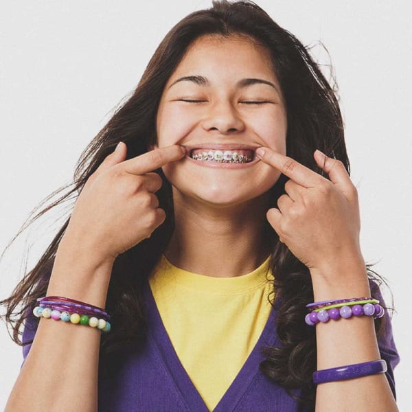 Teen showing off their clean metal braces and teeth