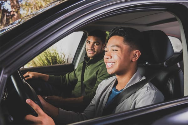 Teen with Invisalign clear aligner tray in car with adult