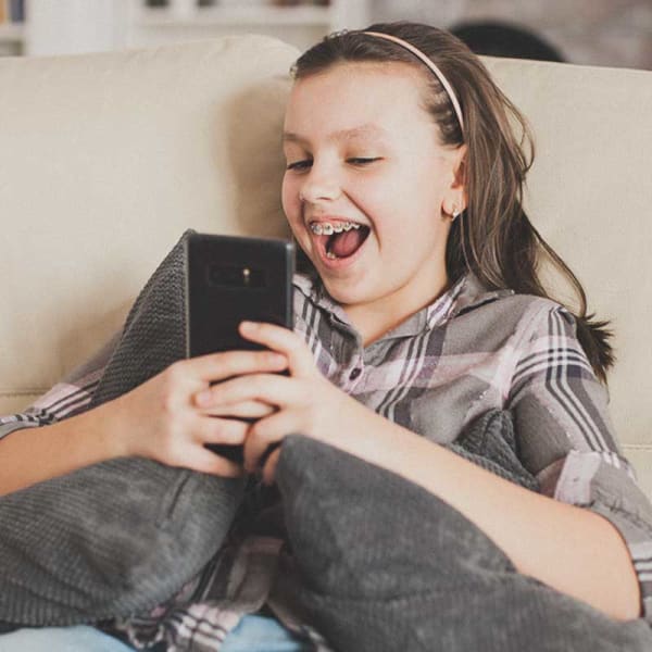 Tween taking a selfie of her new metal braces