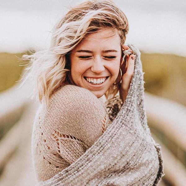 Smiling teenager showing off her teeth after braces treatment