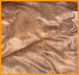 A  Restoration Hardware leather seat cushion, showing a really dry and rough surface from moisture loss, highlighting the need for moisturizing included in our Leather Conditioning treatment.