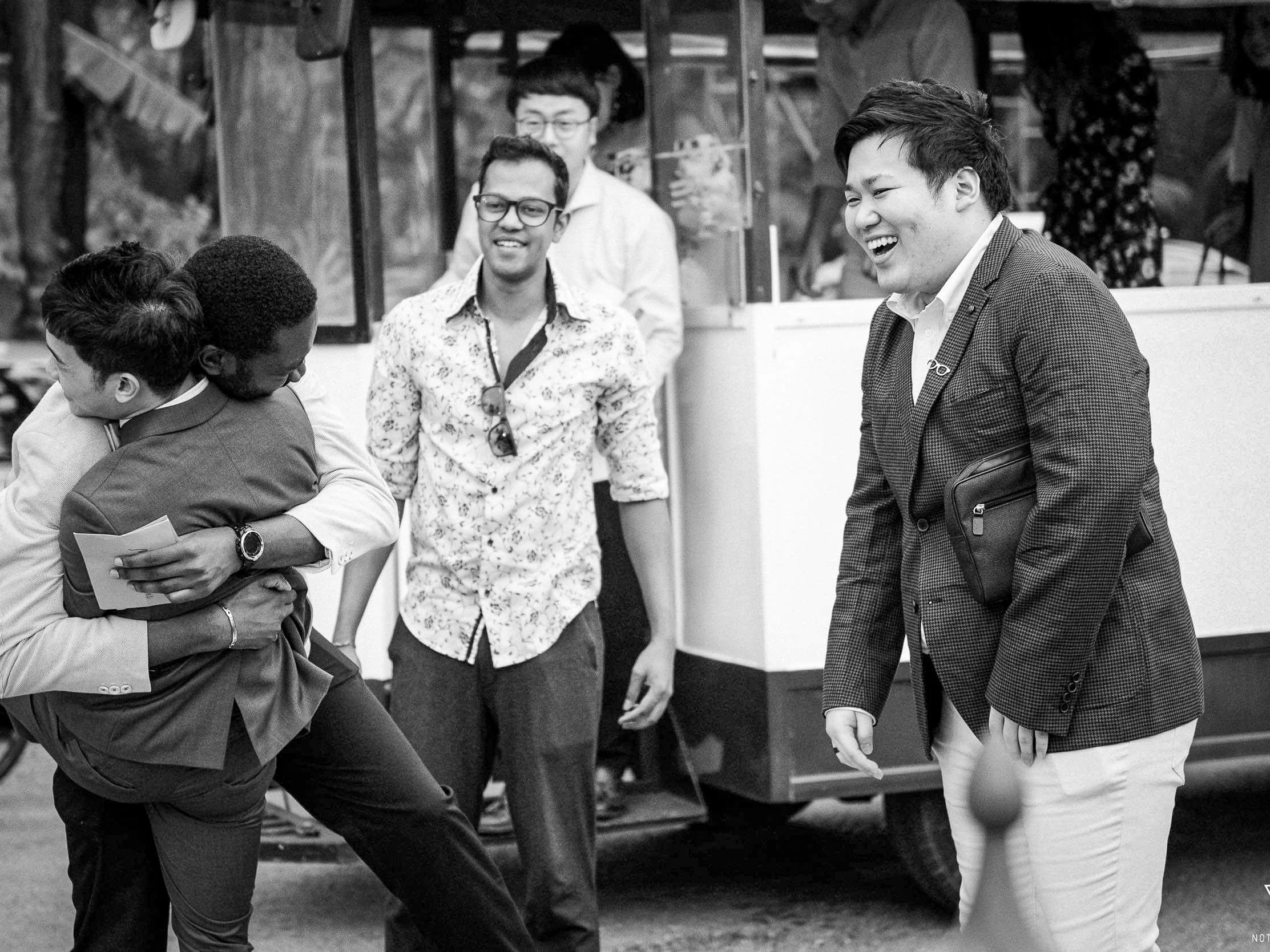 a black and white photo of friends rejoicing