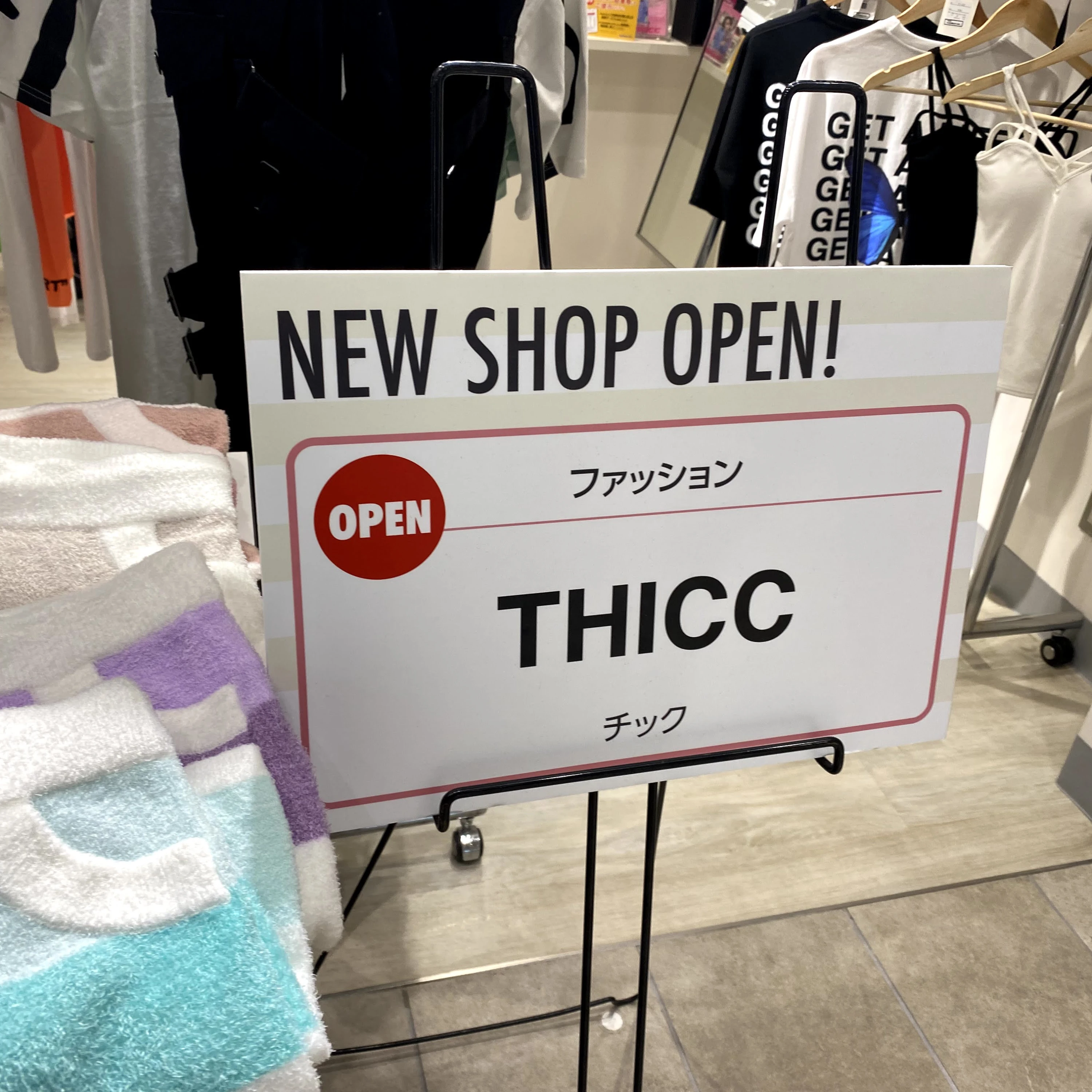 a shop sign that reads thicc