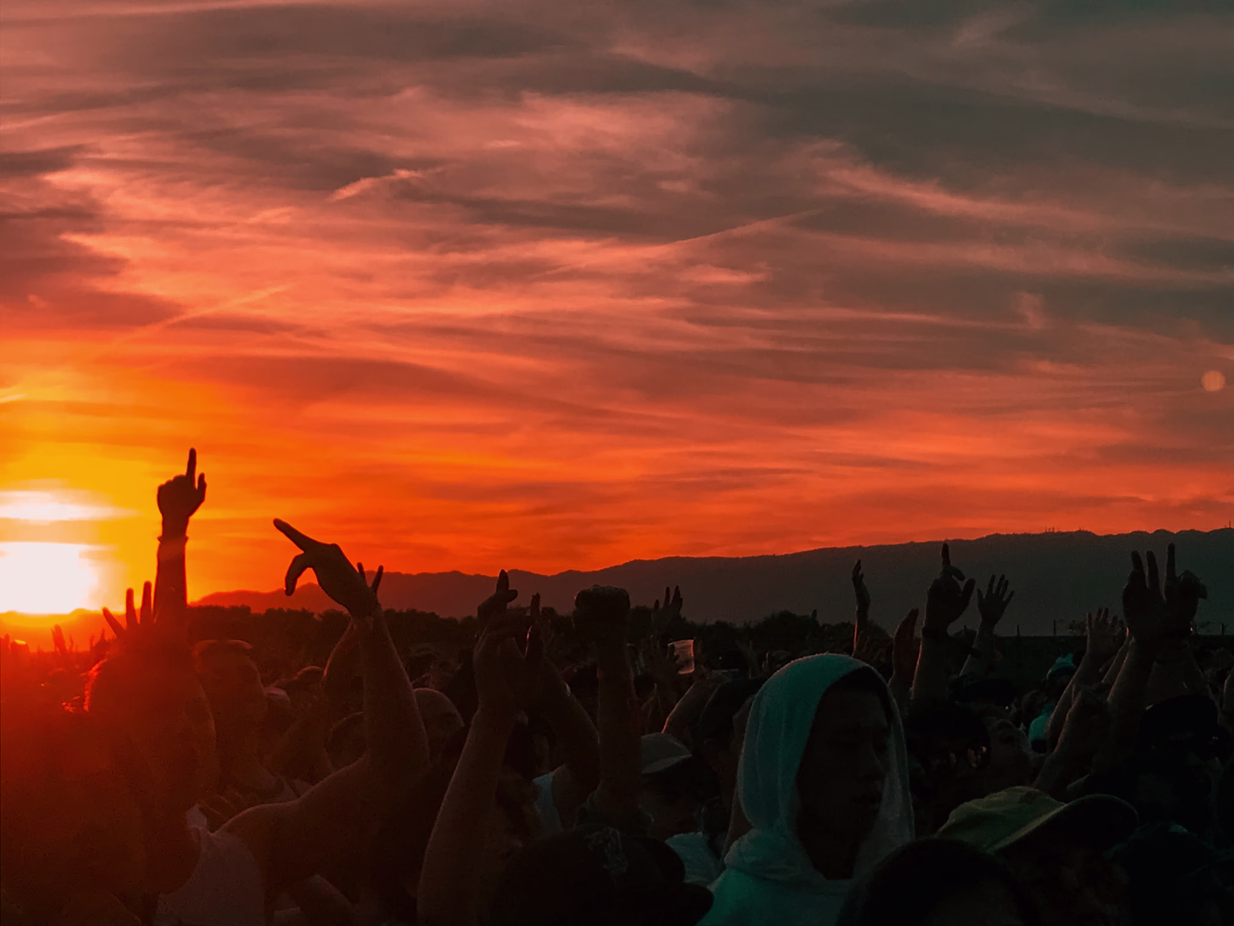 people at a festival drenched by the sun at dusk