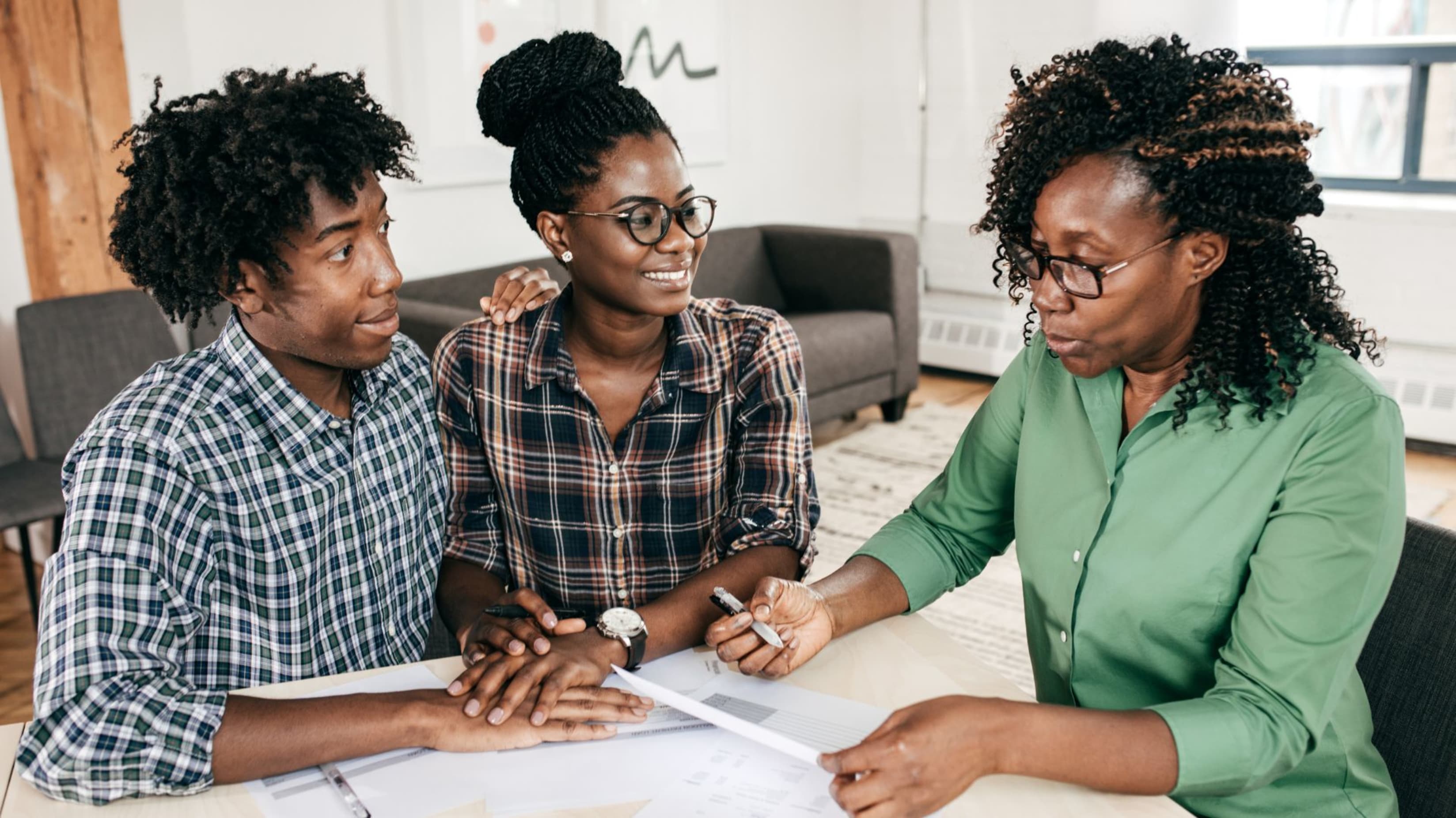 Couple with a real estate agent talking about How to Calculate Your Home Affordability