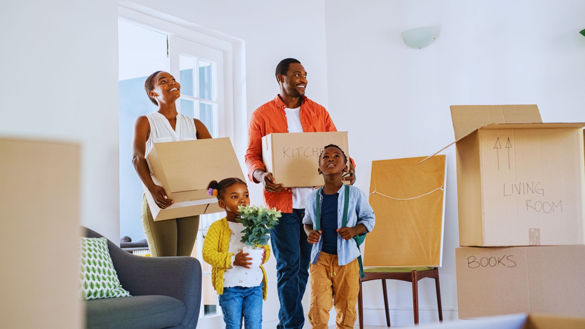 Family moving in and talking about How Much to Budget for Moving Costs