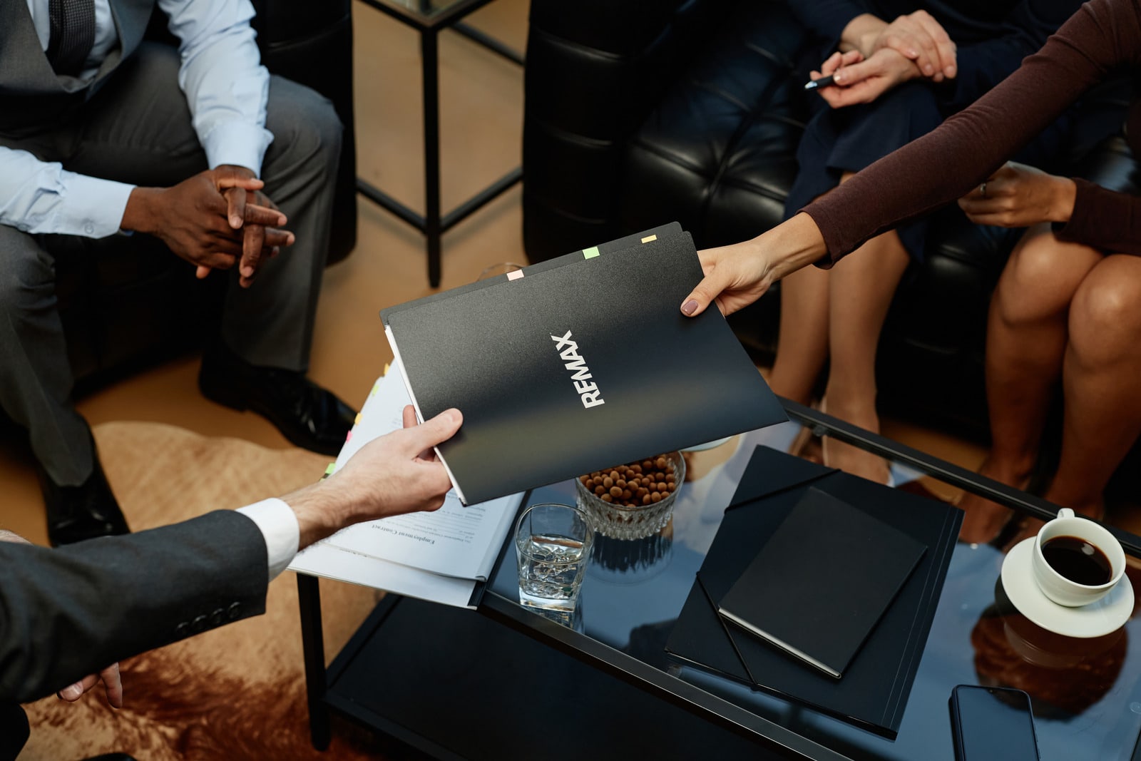 Top,View,Closeup,Of,Business,People,Handing,Binder,With,Documents