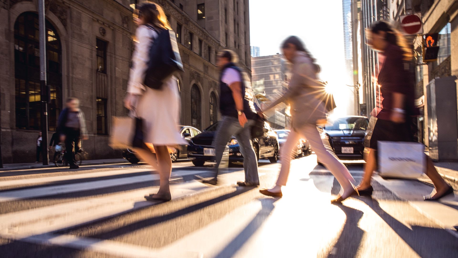 Pedestrians crossing the street in a liveable and affordable neighbourhood in Canada