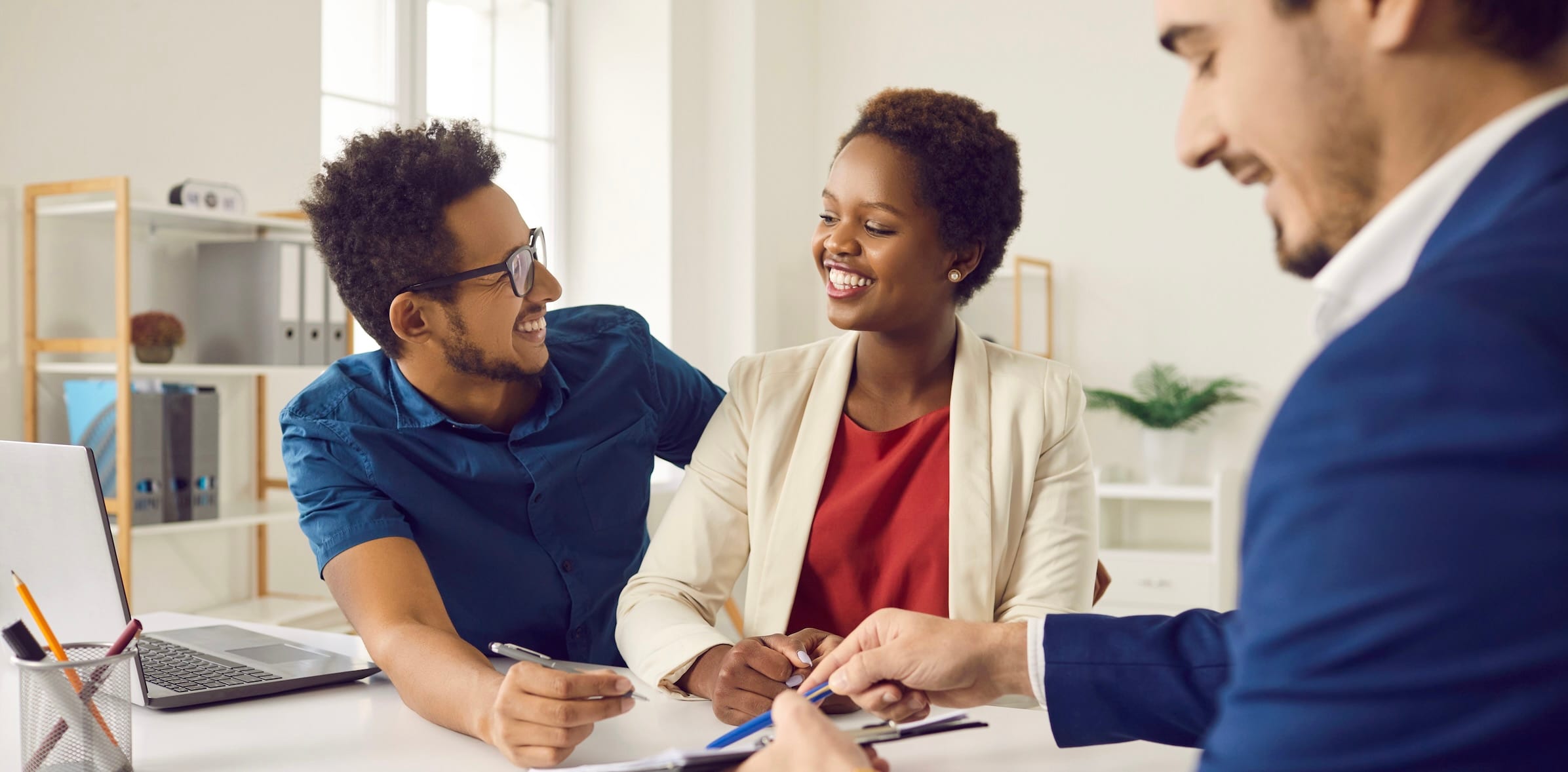 Two people meeting with a real estate agent
