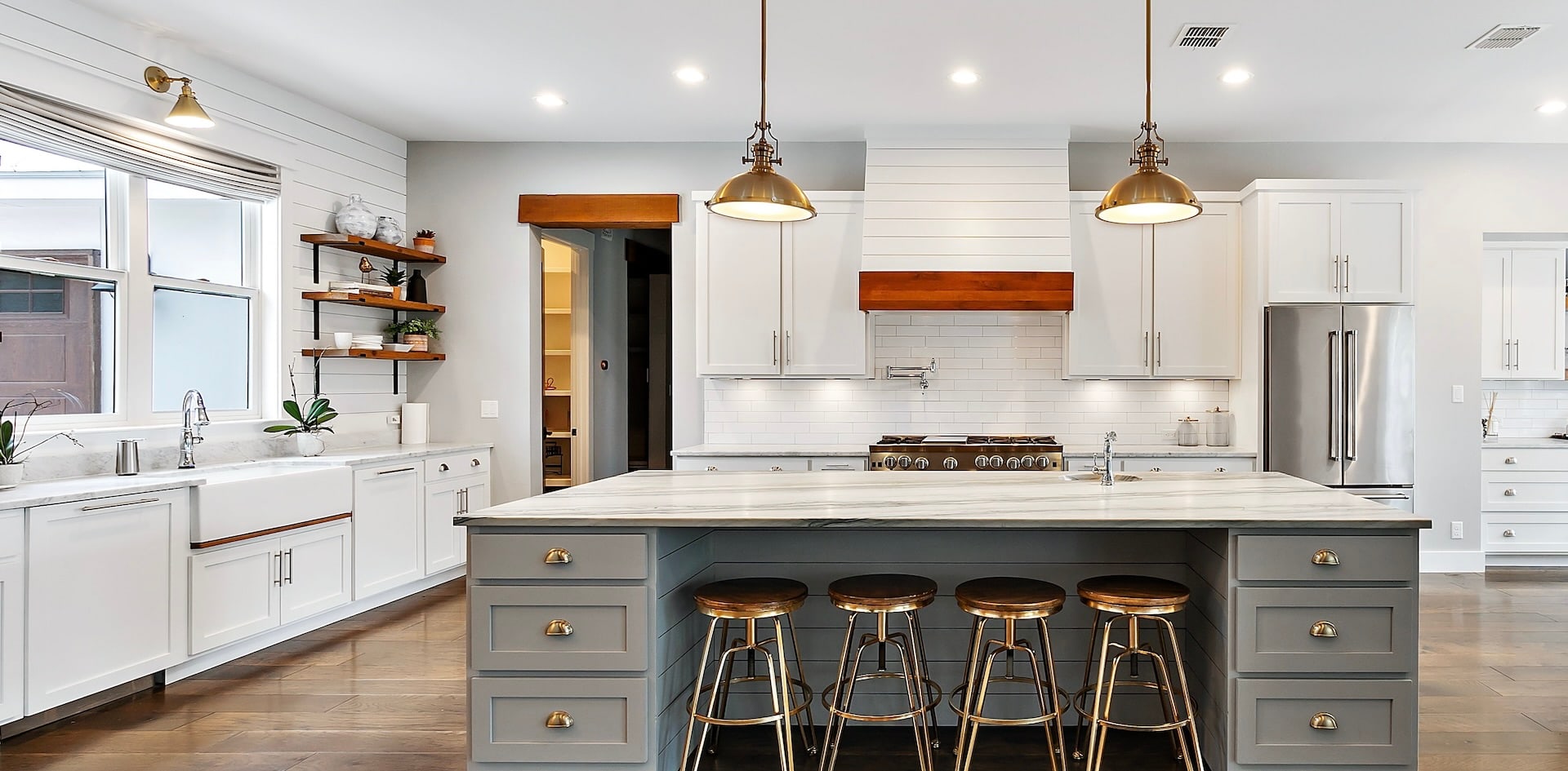 Kitchen with white cabinets and a grey island