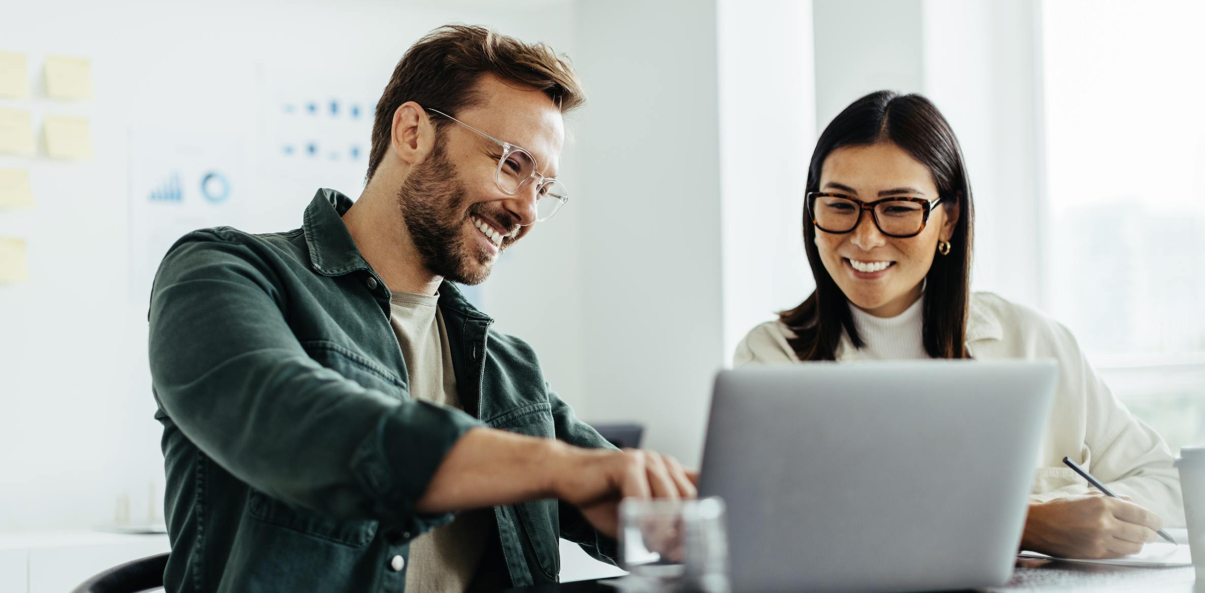 Two people using a laptop computer