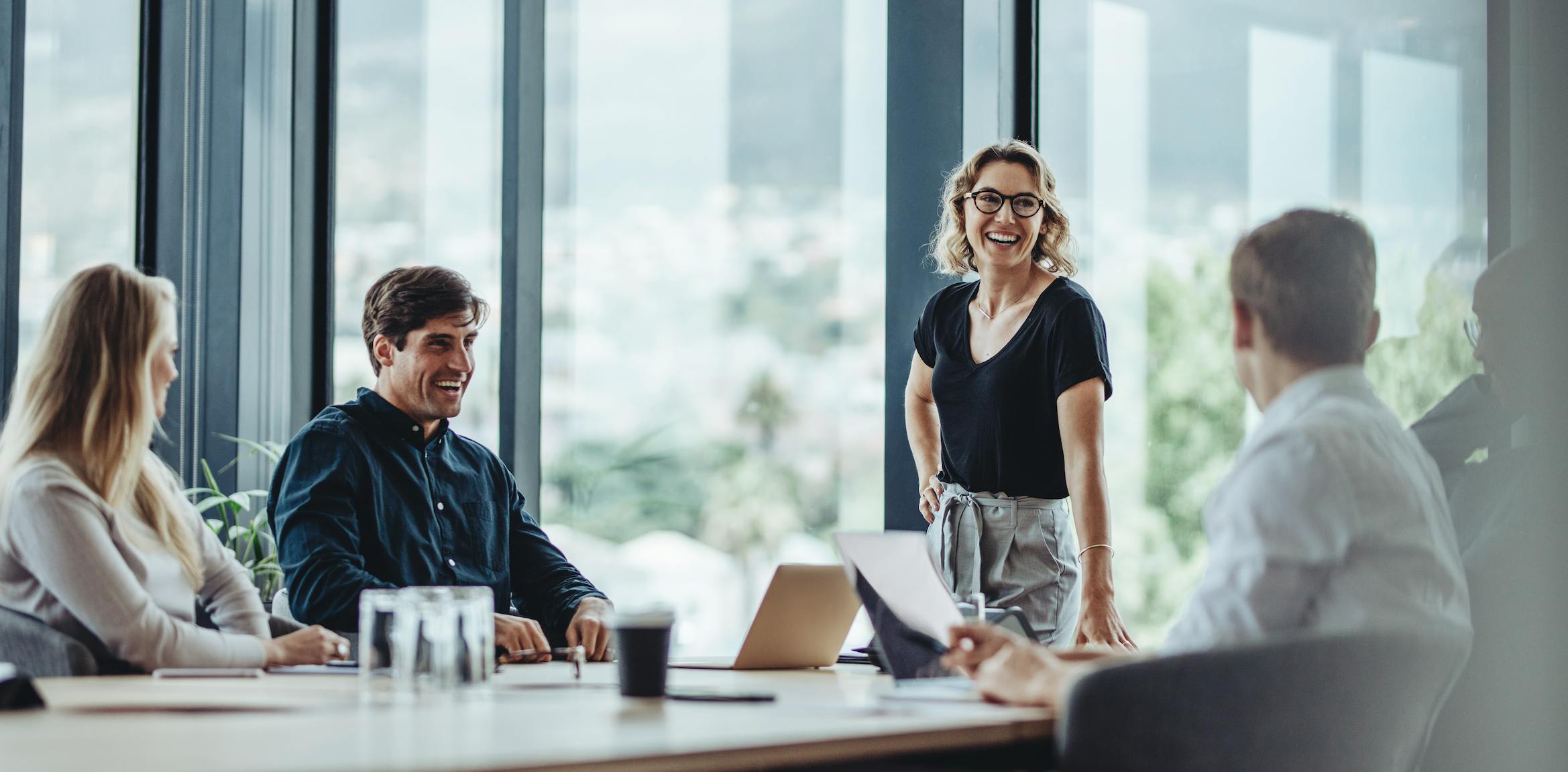 Group of business people gathered around a table.