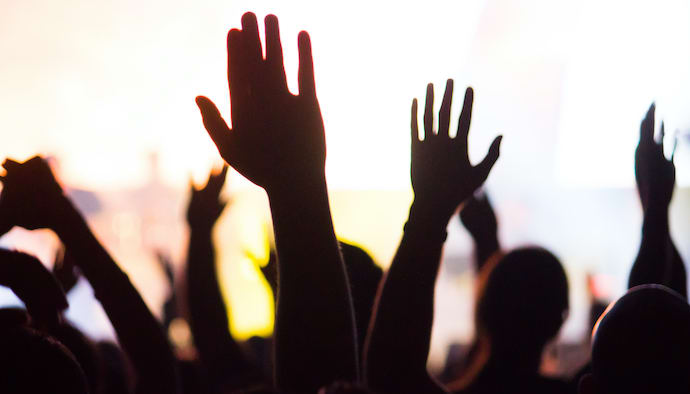 crowd of people with hands up