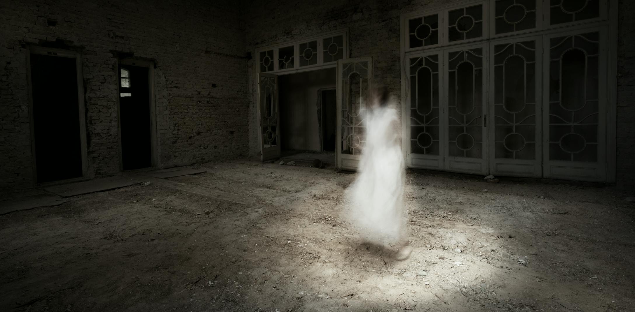 Figure standing in haunted house