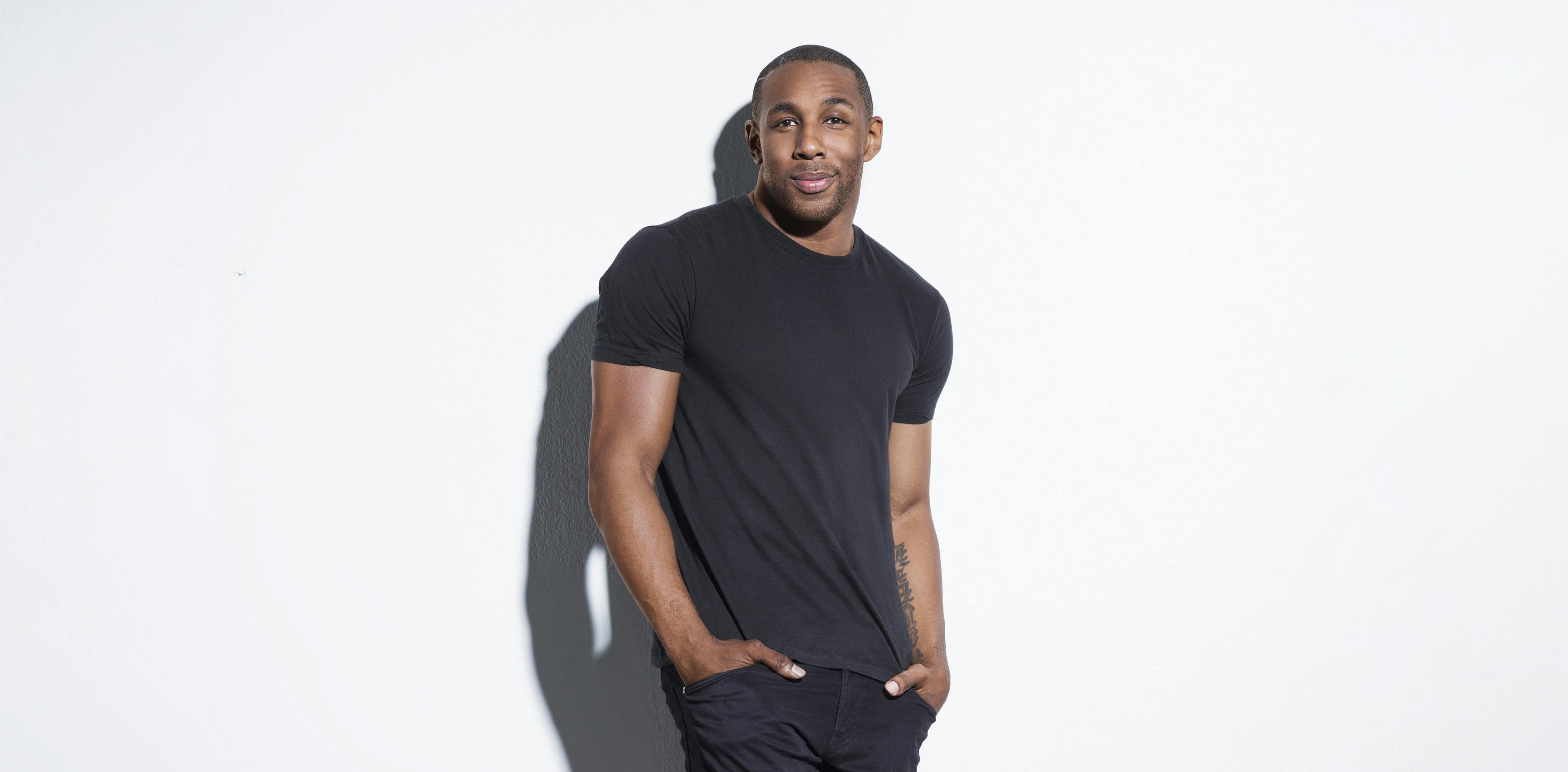 Stephen "tWitch" Boss stands against a white wall